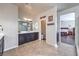 Expansive bathroom with dual sinks, shower and open door to main bedroom at 9655 Shadow Cliff Ave, Las Vegas, NV 89166