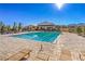 Community pool featuring lounge chairs, clear blue water, and view of the surrounding mountain landscape at 9655 Shadow Cliff Ave, Las Vegas, NV 89166