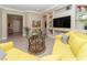 Living room showcases a yellow sectional and a glass table, complemented by built-in shelves and neutral walls at 967 Buggy Whip Ct, Mesquite, NV 89034