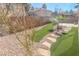 Landscaped backyard featuring a decorative stone gravel area, concrete patio, and artificial turf at 9870 Giant Steps Ct, Las Vegas, NV 89141