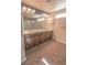 Bathroom featuring double sinks, a large mirror, and ample counter space at 9870 Giant Steps Ct, Las Vegas, NV 89141