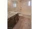 Bathroom showcasing a double sink vanity, toilet, and a shower-tub combination with tile surround at 9870 Giant Steps Ct, Las Vegas, NV 89141