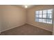 Bedroom with neutral walls, carpeted flooring, and a window providing natural light at 9870 Giant Steps Ct, Las Vegas, NV 89141