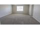 Large bedroom featuring carpet flooring, a window and an ensuite bathroom at 9870 Giant Steps Ct, Las Vegas, NV 89141