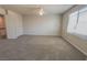 Spacious bedroom with carpeted floors, a ceiling fan, and a window for natural light at 9870 Giant Steps Ct, Las Vegas, NV 89141