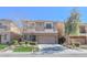 Two story home with a two car garage, stone accents and xeriscaped front yard at 9870 Giant Steps Ct, Las Vegas, NV 89141