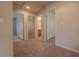 Hallway featuring carpeted floors and multiple doorways leading to various rooms in the home at 9870 Giant Steps Ct, Las Vegas, NV 89141