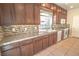 Traditional kitchen features wood cabinets, granite countertops, tile backsplash, and stainless steel appliances at 9870 Giant Steps Ct, Las Vegas, NV 89141