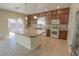 Bright eat-in kitchen features an island, dark cabinets, and white appliances at 9870 Giant Steps Ct, Las Vegas, NV 89141