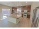 Bright eat-in kitchen features an island, dark cabinets, and stainless steel appliances at 9870 Giant Steps Ct, Las Vegas, NV 89141