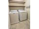 Laundry room equipped with washer, dryer, and overhead shelving at 9870 Giant Steps Ct, Las Vegas, NV 89141