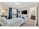 Comfortable bedroom featuring neutral decor, window, and view into the bathroom at 9972 Trailing Vine St, Las Vegas, NV 89183