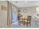 Bright dining area featuring a round table, tile floors, and sliding glass doors at 9972 Trailing Vine St, Las Vegas, NV 89183