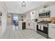 Bright kitchen with white cabinets, stainless steel appliances, and a breakfast bar area at 9972 Trailing Vine St, Las Vegas, NV 89183