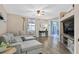 Bright living room with hardwood floors, neutral decor, and a view into the dining area at 9972 Trailing Vine St, Las Vegas, NV 89183