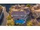 Captivating aerial view showcasing the home's layout, landscaping, and inviting pool area in a well-designed neighborhood at 10008 Peak Lookout St, Las Vegas, NV 89178