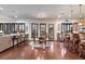 Bright dining room boasts dark shutters, wood floors, chandelier, and a bar top in the background at 10008 Peak Lookout St, Las Vegas, NV 89178