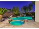 Inviting backyard pool and hot tub featuring a rock waterfall and lush landscaping at 10008 Peak Lookout St, Las Vegas, NV 89178