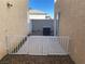 Fully gravel backyard featuring a fence, utility box, and partial view of other houses at 10047 Fine Fern St, Las Vegas, NV 89183