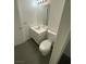 Bathroom features a white toilet, sink, and cabinet under a mirror at 10047 Fine Fern St, Las Vegas, NV 89183