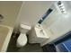 A full bathroom, features a tub and shower combination, white vanity and dark tile floors at 10047 Fine Fern St, Las Vegas, NV 89183