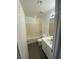 Bright bathroom featuring a tub-shower combo, single sink vanity, and modern fixtures at 10047 Fine Fern St, Las Vegas, NV 89183