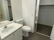 Bathroom featuring a vanity, toilet, and a view to the closet behind sliding doors at 10047 Fine Fern St, Las Vegas, NV 89183