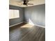 Bright bedroom features modern ceiling fan, natural light, and wood-look flooring at 10047 Fine Fern St, Las Vegas, NV 89183
