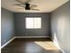 Bright bedroom with wood floors, ceiling fan, and a window offering ample natural light at 10047 Fine Fern St, Las Vegas, NV 89183