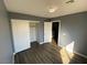 Bedroom features laminated wood floor, closet, and window at 10047 Fine Fern St, Las Vegas, NV 89183