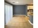 An airy dining room and kitchen area with tile flooring and large sliding doors at 10047 Fine Fern St, Las Vegas, NV 89183