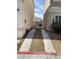 Wide driveway leading back to a fenced yard with rock landscaping at 10047 Fine Fern St, Las Vegas, NV 89183