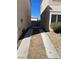 Wide driveway leading back to a fenced yard with rock landscaping at 10047 Fine Fern St, Las Vegas, NV 89183