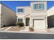 Two-story home featuring teal shutters and a one-car garage, landscaped front yard and driveway at 10047 Fine Fern St, Las Vegas, NV 89183