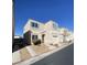 A two-story single Gathering home with a one-car garage, landscaped front yard and driveway at 10047 Fine Fern St, Las Vegas, NV 89183