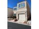 Two-story home featuring teal shutters and a one-car garage, landscaped front yard and driveway at 10047 Fine Fern St, Las Vegas, NV 89183