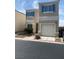 Charming two-story home featuring light stucco, teal shutters, and a one-car garage at 10047 Fine Fern St, Las Vegas, NV 89183