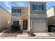 Charming two-story home featuring light stucco, teal shutters, and a one-car garage at 10047 Fine Fern St, Las Vegas, NV 89183