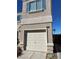 Beige garage with light trim and a tan driveway in front at 10047 Fine Fern St, Las Vegas, NV 89183