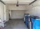 Attached garage with functional storage shelves, door to house, and space for multiple bins at 10047 Fine Fern St, Las Vegas, NV 89183
