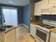Well-equipped kitchen with stainless steel appliances, tile floor, and granite counters at 10047 Fine Fern St, Las Vegas, NV 89183
