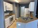Functional kitchen with stainless steel appliances, granite countertops, and white cabinetry at 10047 Fine Fern St, Las Vegas, NV 89183