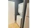 A modern laundry room with stacked washer and dryer and tile flooring at 10047 Fine Fern St, Las Vegas, NV 89183