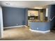 A spacious living room featuring ceramic tile flooring, gray walls, and white cabinets at 10047 Fine Fern St, Las Vegas, NV 89183