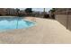 Beautiful community pool with clear blue water and well-maintained surroundings with fencing at 10047 Fine Fern St, Las Vegas, NV 89183
