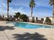 Inviting community pool surrounded by palm trees and well-maintained grounds, perfect for relaxation at 10047 Fine Fern St, Las Vegas, NV 89183
