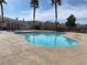 Community pool with clear blue water, surrounded by well maintained grounds, and a nearby pool house at 10047 Fine Fern St, Las Vegas, NV 89183