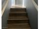 A wooden staircase leads to another level of the home, connecting different spaces at 10047 Fine Fern St, Las Vegas, NV 89183