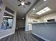 The stylish living room showcases a modern ceiling fan and view into the kitchen at 10301 Broom Hill Dr, Las Vegas, NV 89134