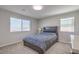 This bedroom features carpet, natural light, and a comfortable bed at 10590 Dryades Ave, Las Vegas, NV 89166